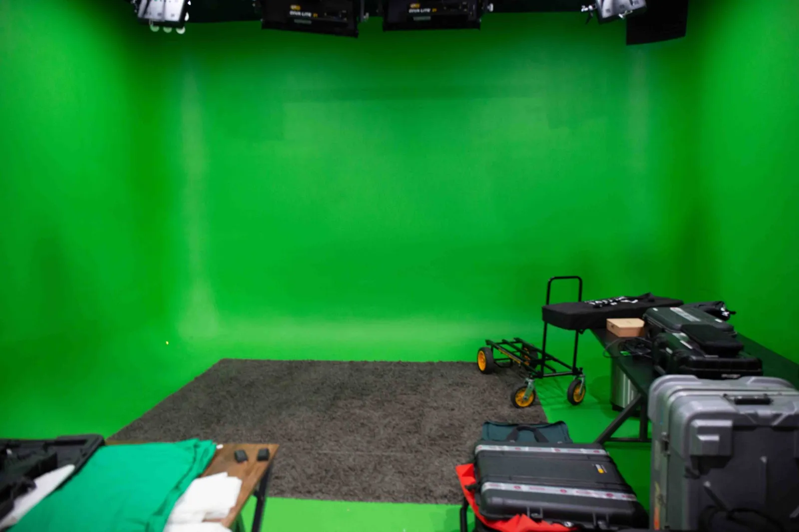 The Killerspots green screen cyclorama with overhead LED panels and production cases on set